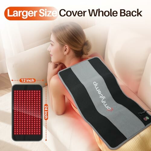 A person using a large infrared heating pad on their back.