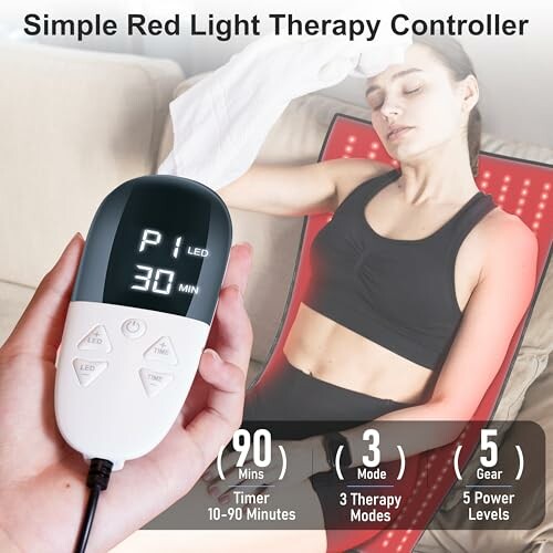 Person using a simple red light therapy controller with settings display.