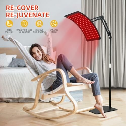 Woman in chair using red light therapy lamp for relaxation.